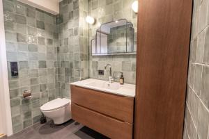 a bathroom with a sink and a toilet at Town house with good view on top of Tromsø Island in Tromsø +42 photos