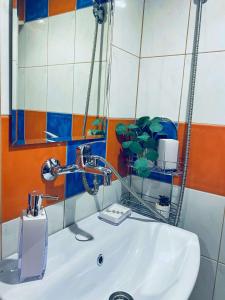 a bathroom with a sink with a faucet at Къща за гости Василеви in Bratsigovo