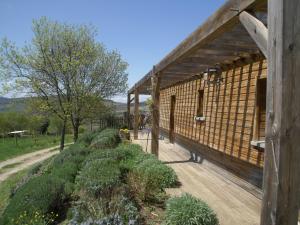 a large wooden building with a wooden deck at Modern Chalet in Roquetaillade with Swimming Pool in Roquetaillade