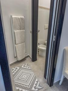 a bathroom with a toilet and a sink at Casa del Lauro - Apartment in Locorotondo +6 photos