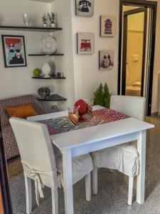 a dining room table with two chairs and a white table at Casa del Lauro - Apartment in Locorotondo +6 photos