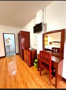 a bedroom with a desk and a bed and a mirror at Vang vieng guesthouse in Vang Vieng +38 photos