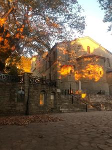 a large stone building with fire coming out of it at Nature Paradise Apartment in Kardítsa