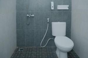 a bathroom with a toilet and a shower at The Samora Living in Yogyakarta +23 photos