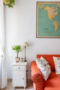 a living room with a couch and a map on the wall at Maurice's Apt, hidden gem in Rome for food lovers in Rome