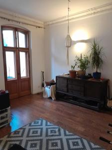 a living room with a dresser and a door at Yoda house in Legnica