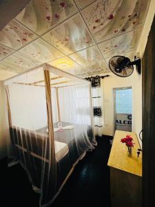 a bedroom with a canopy bed in a room at Newton House in Hiriketiya