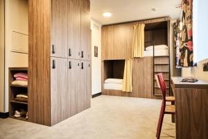 a small room with a closet and a bedroom at JOST Auberge de Jeunesse Lille Centre in Lille
