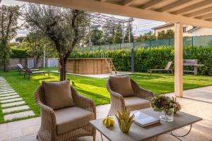 a patio with two chairs and a table at Egidio City Farmhouse in Lucca