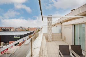 a balcony of a building with chairs on it at Espinho Retreat with Balcony in Espinho +28 photos