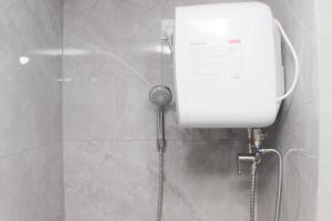 a shower in a bathroom with a shower at Fancy and Nice Studio Apartment at Sayana Bekasi By Travelio in Bekasi +13 photos