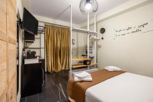 a bedroom with a bed and a desk and a television at Al Borghetto marinaro in Palermo