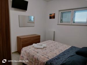 a bedroom with a bed with two towels on it at casa vacanze in Tortoreto Lido +13 photos