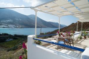 a white house with a view of the water at Amorgi Studios in Aegiali +20 photos
