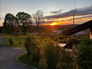 a sunset over a field with the sun setting at La Chabraque in Le Barboux