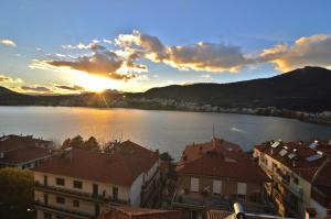 a view of a lake with buildings and the sunset at Konstantina's Sky View in Kastoria