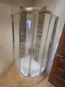 a shower with a glass door in a bathroom at Anchor Gardens Villa in Lindal in Furness +11 photos