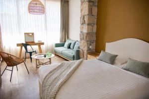 a bedroom with a bed and a couch in a room at Boutique Hotel & Spa la Villa Cap Ferrat in Saint-Jean-Cap-Ferrat +37 photos