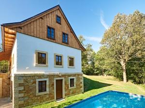 a house with a swimming pool in front of it at Na jelení stezce in Chřibská