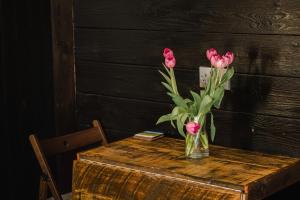 a vase of pink flowers sitting on a table at A Place In the Pennines in Huddersfield