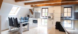 a kitchen with a table and chairs in a room at Obermühle Duderstadt in Duderstadt