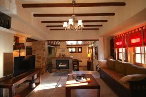 a living room with a couch and a fireplace at Pine Lodge by Ski Alure in Arachova