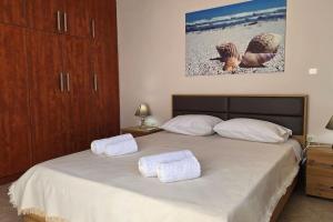 a bedroom with a bed with two towels on it at Calliestia 7 in Chios