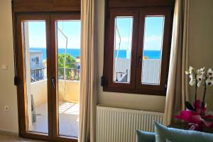 a room with a window with a view of the ocean at Calliestia 7 in Chios +6 photos