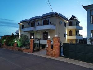 a large white house with a black fence at Calliestia 7 in Chios