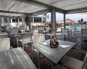 a restaurant with tables and chairs on a deck at Boutique Hotel & Spa la Villa Cap Ferrat in Saint-Jean-Cap-Ferrat