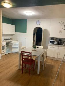 a kitchen with a table and chairs in a room at T2 58m2 Allée des Bains-Tarifs cure in Luchon