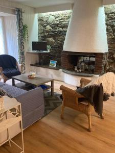 a living room with a large stone fireplace at T2 58m2 Allée des Bains-Tarifs cure in Luchon