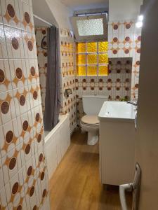 a bathroom with a toilet and a sink and a tub at T2 58m2 Allée des Bains-Tarifs cure in Luchon