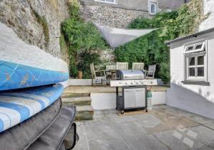 a backyard with a grill and a table with chairs at Beautiful House in Bideford on Peaceful Street in Bideford