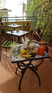 a table with fruits and vegetables on a balcony at B&B DieMme Amalfi Coast in Vietri sul Mare