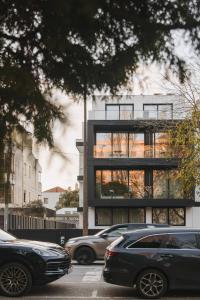 a building with cars parked in front of it at Timbre Boavista in Porto