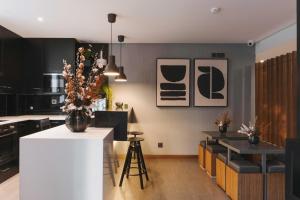 a kitchen with black and white walls and a white counter at Timbre Boavista in Porto