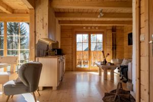 a living room in a log cabin with a television at Domki pod Gubałówką in Zakopane