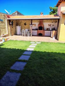 a garden with a stone walkway in the yard at Aconchego da Vovó in Araruama