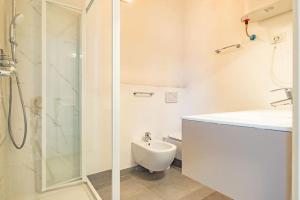 a bathroom with a shower and a sink and a toilet at Baia di Spartaia 1 in Procchio +39 photos