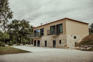 a house with a balcony on top of it at Quinta das Areias - Solar da Pena in Braga