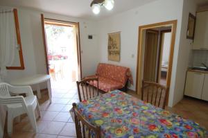 a living room with a table and a chair at Cozy flat in Rosolina in Rosolina Mare