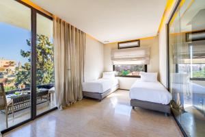 Un dormitorio con dos camas y una gran ventana. en Luxury 2 BDR Hivernage, en Marrakech