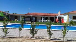 a house with a swimming pool in front of a house at Spacious villa with private pool in Grândola in Grândola