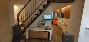 a living room with a staircase and a table and chairs at Holiday House da Carlo in Catania