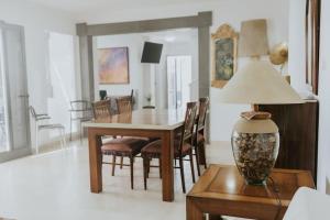 a dining room with a table and chairs and a lamp at Villa Lanzarote Zen in Playa Blanca