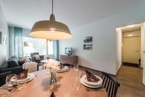 a dining room with a table and a living room at Forenom Serviced Apartments Helsinki Lapinlahdenkatu in Helsinki