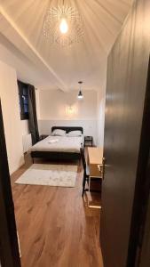 a room with a bed and a table in it at Cocon Coeur de Ville in Villefranche-de-Lauragais