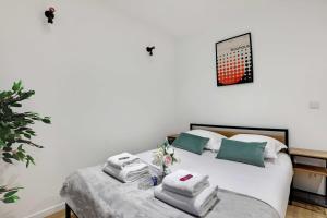 a bedroom with a bed with towels on it at Cozy studio -2P- Sorbonne Institute- Latin quarter in Paris +3 photos