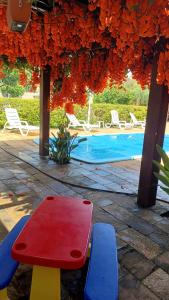 a picnic table and chairs next to a swimming pool at Flat confortável in Brasilia +1 photo